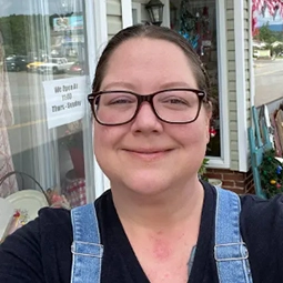 Selfie image of woman in front of storefront